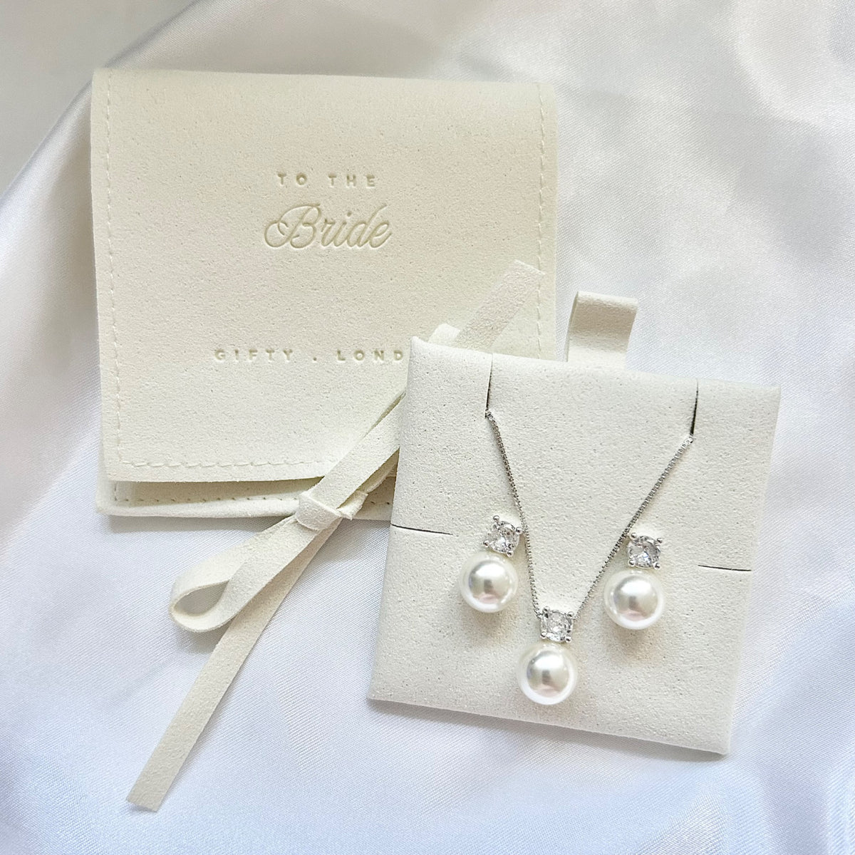 Silver pearl necklace and earrings with cream bridal jewellery pouch