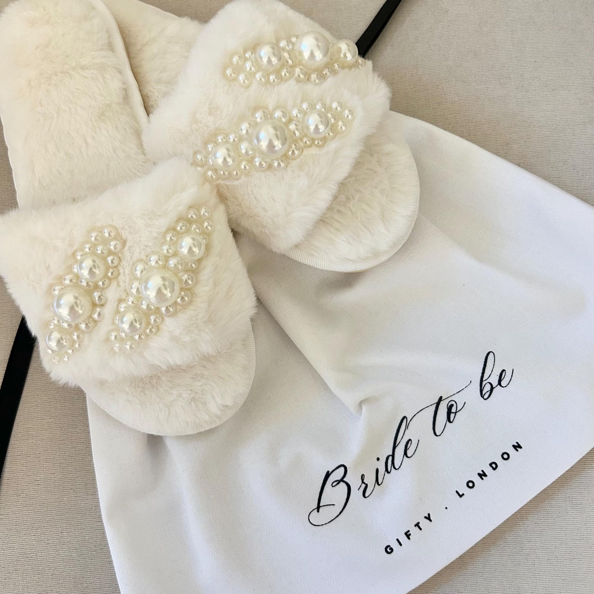 Cream pearl bridal slippers with Bride To Be dust bag