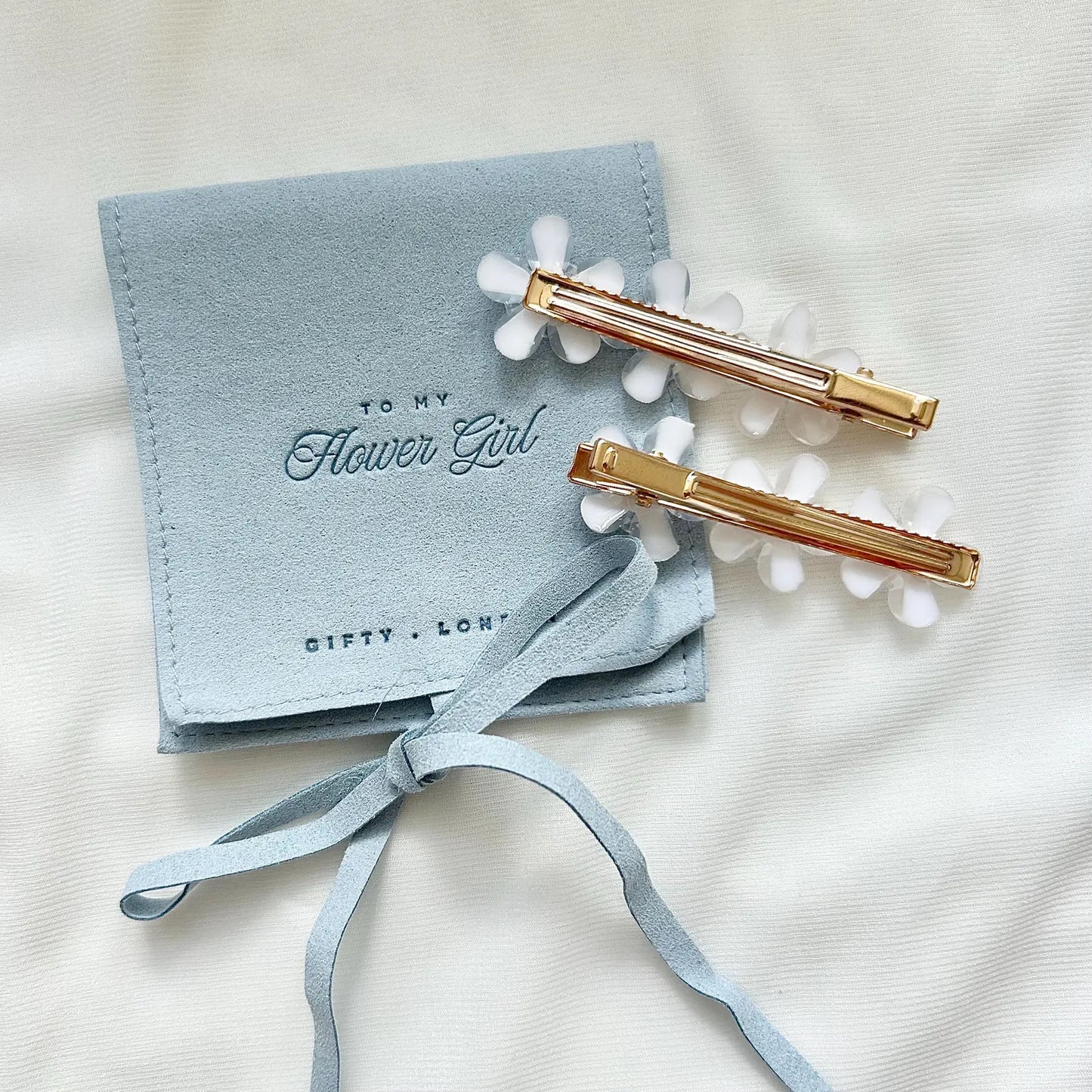 Flower girl gift with white floral hair clips and blue keepsake pouch